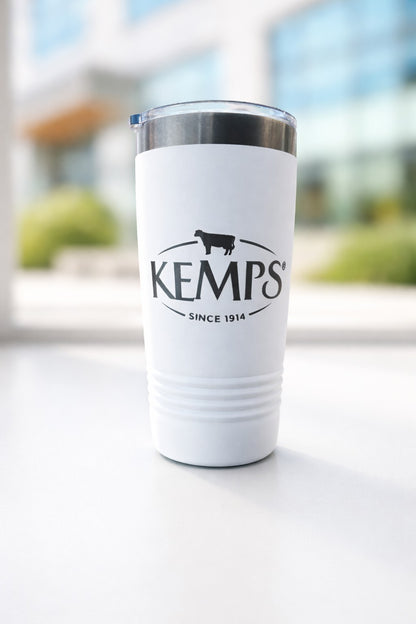 White tumbler with Kemp's logo on a blurred outdoor background