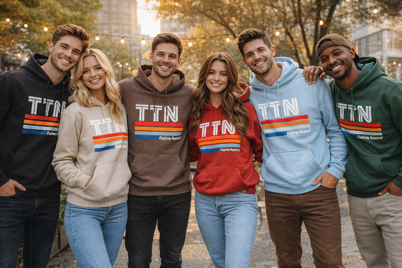 Group of six friends wearing hoodies with 'TTN' logo outdoors.